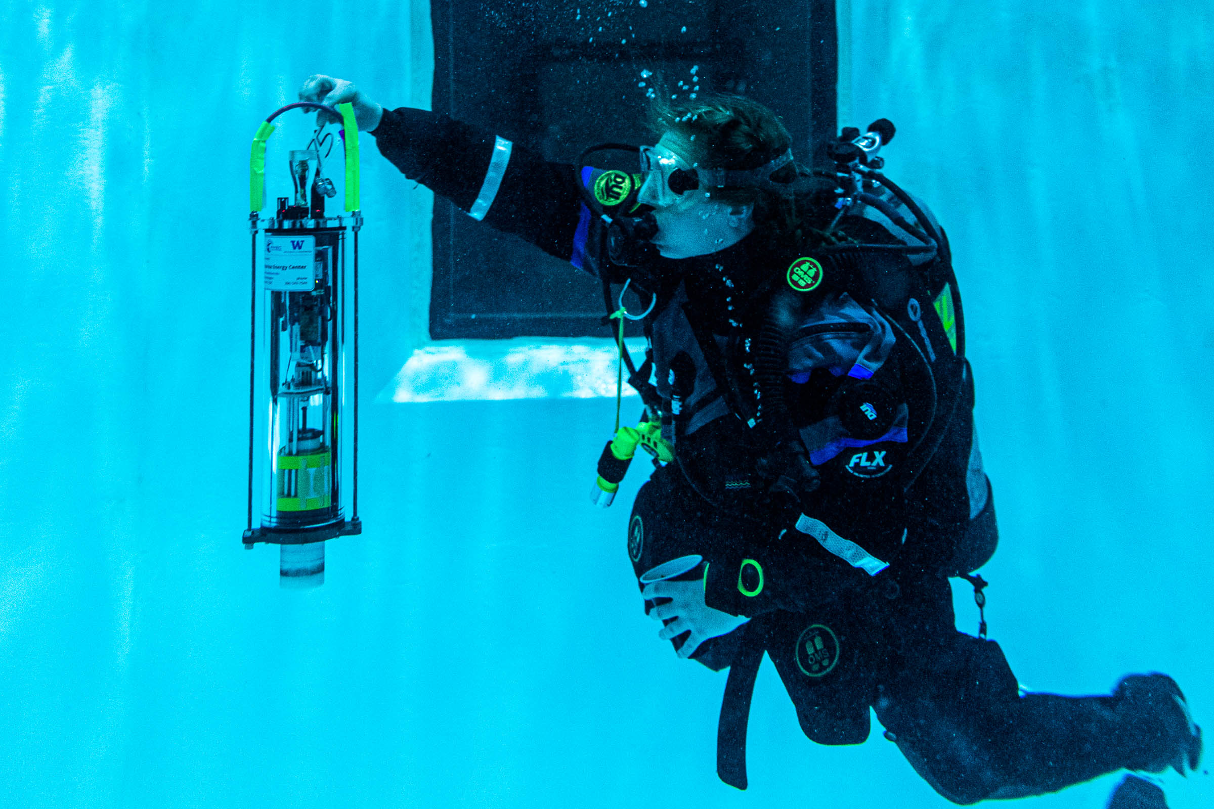 A diver underwater holding a µFloat