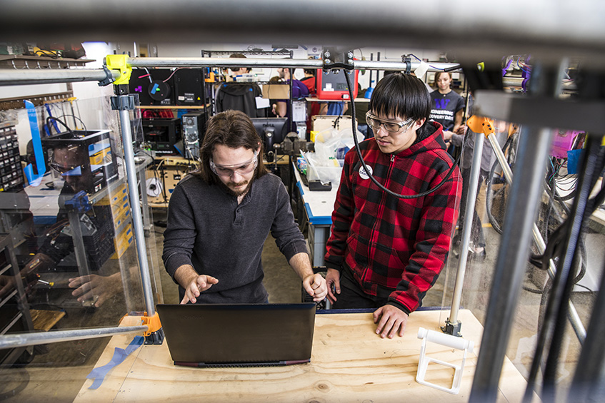 image of two students at laptop