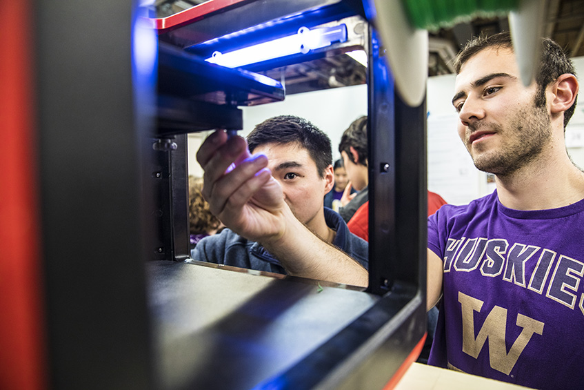 image of students maintaining 3d printer