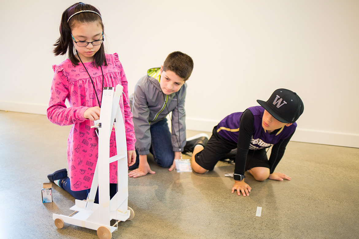 >A student readies a gravity car for launch