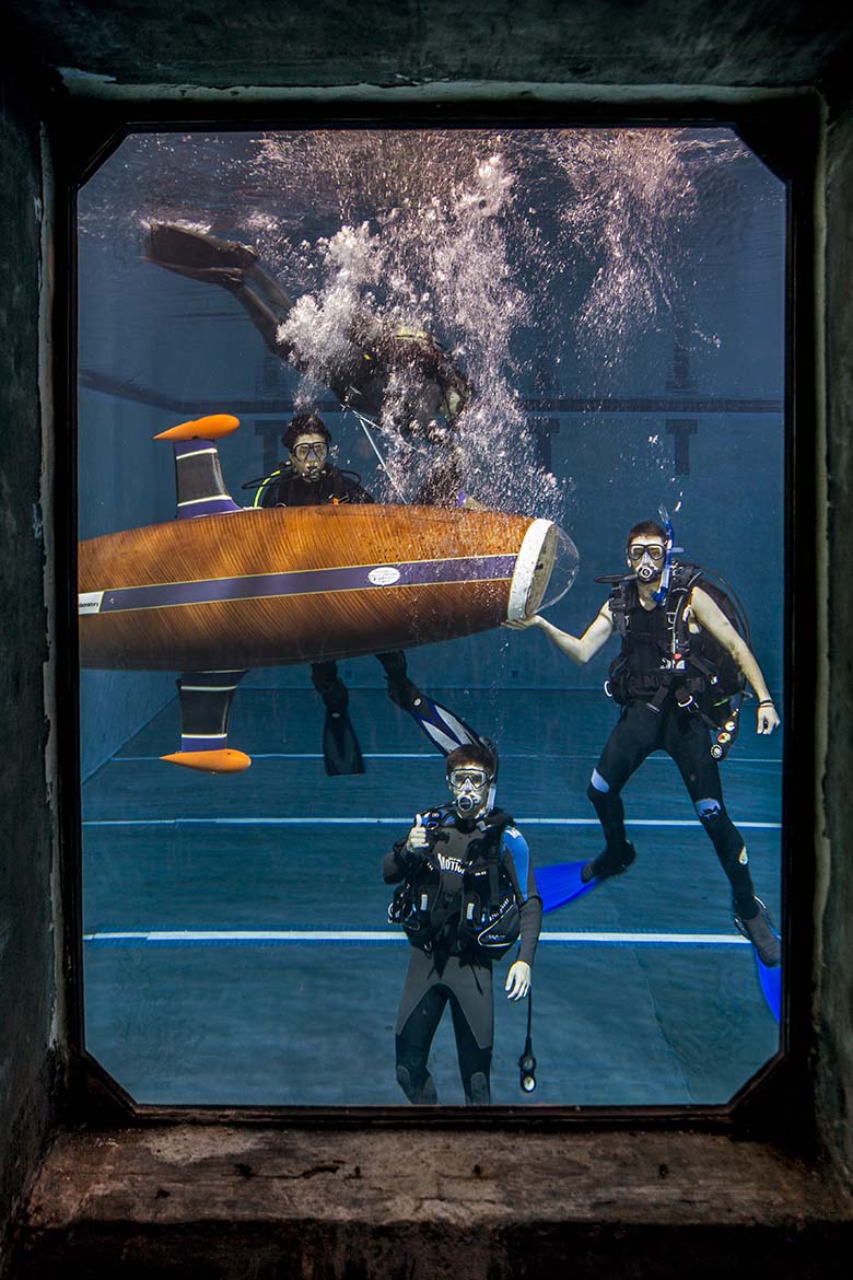 Scuba divers posing in front of the HPS