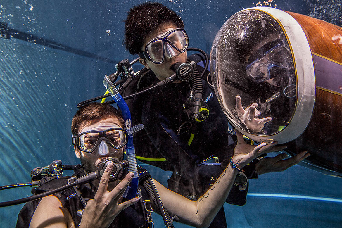 Students posing with HPS under water