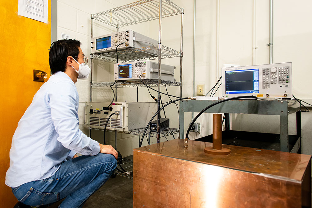 A researcher looking at an electronic device