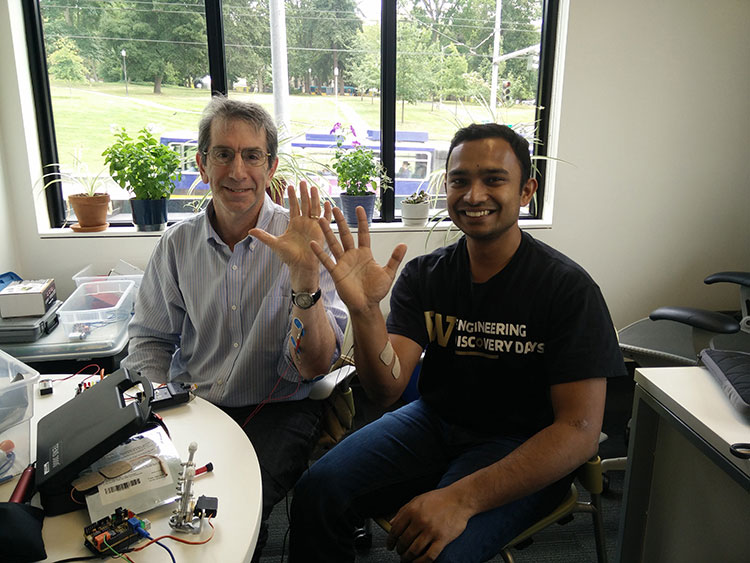 Gaurav Mukherjee sitting with CNT executive director and education director Eric Chudler