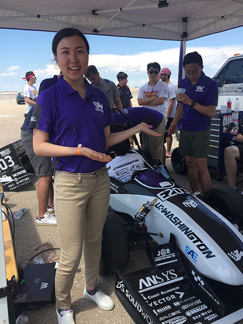 Student pointing at a race car