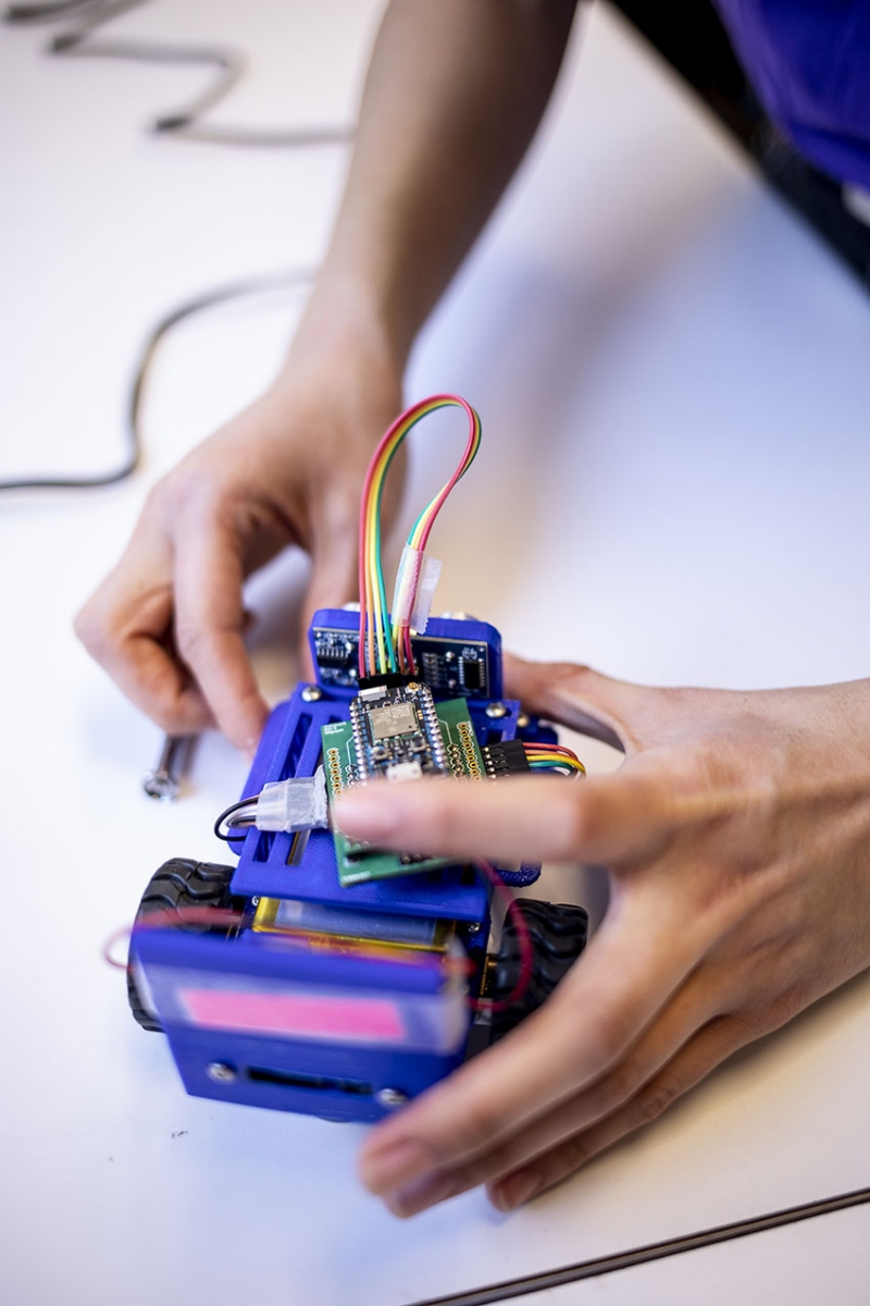 Berger working on a small robotic vehicle