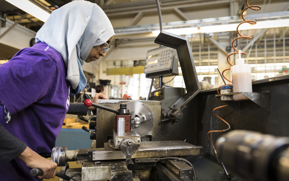 Fethya Ibrahim operating a machine