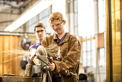 Ashley Combs using a plasma cutter