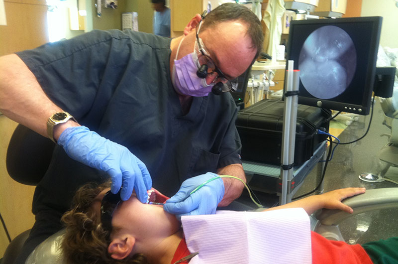 Dr. Joel Berg operating an optical dental device