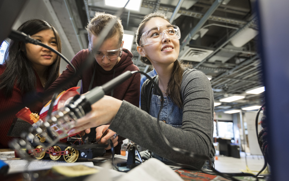 Students soldering a toy