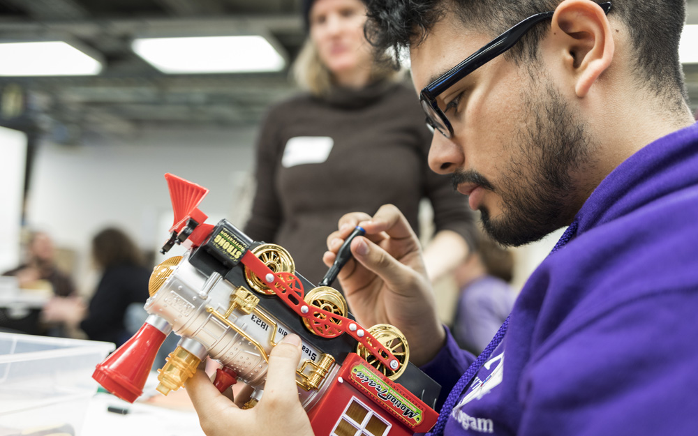 Student hacking a toy train