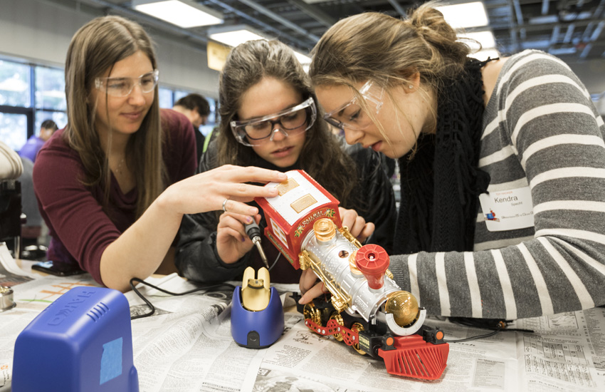 Students hacking a toy train