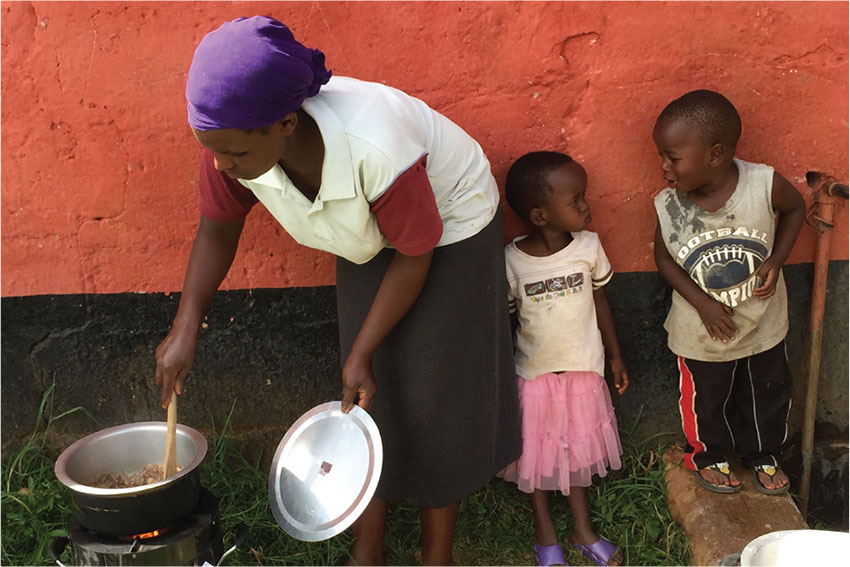 Woman cooking outdoors