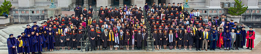 graduates standing together on steps