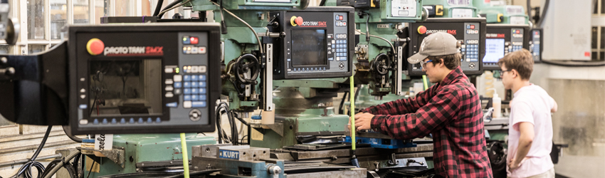 Student using machine shop equipment