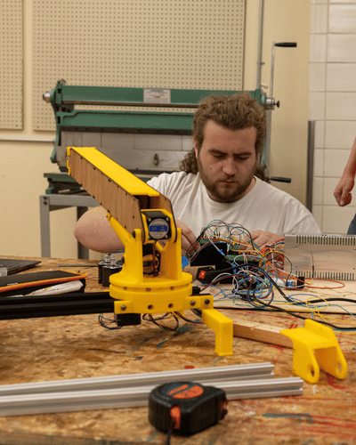 One student works on wiring for the controls system.