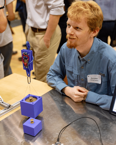 A close-up image of a student behind the crane cable that can attach to objects.