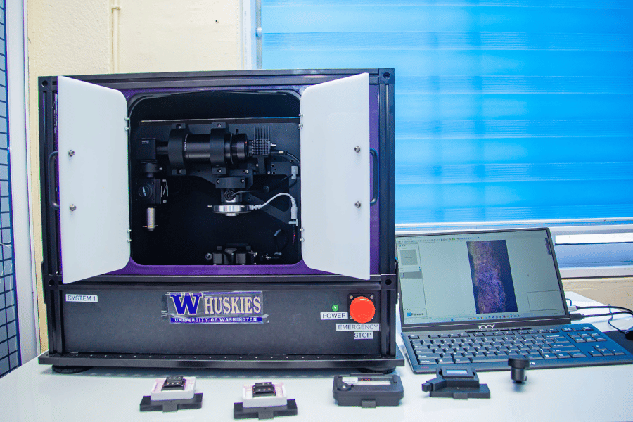 The CoreView machine with a microscope is next to a laptop that shows the imaging of the tissue.