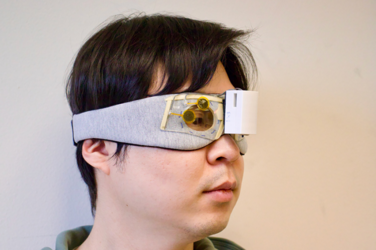 A researcher wearing a mask with sensors attached to monitor brain pressure.