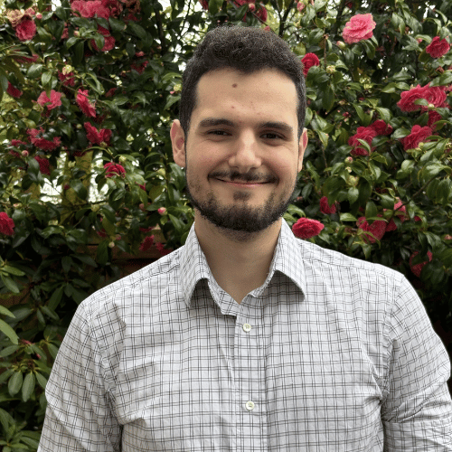 Headshot of Liam Knudsen smiling outside.
