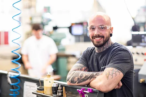 Raymond in machine shop wearing safety glasses