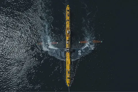 an aerial view of a yellow boat in the water