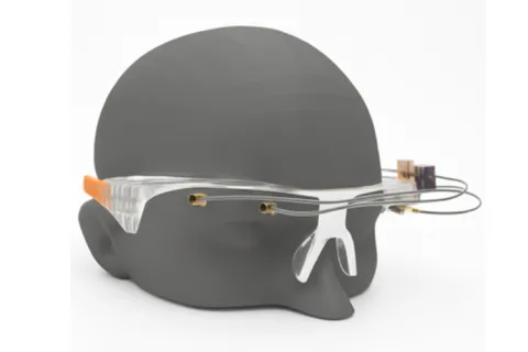 A glasses frame with sensors attached on a model of a head.