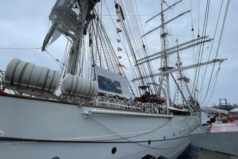 Tall ship docked at a pier