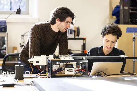 Two people collaborating on a workshop