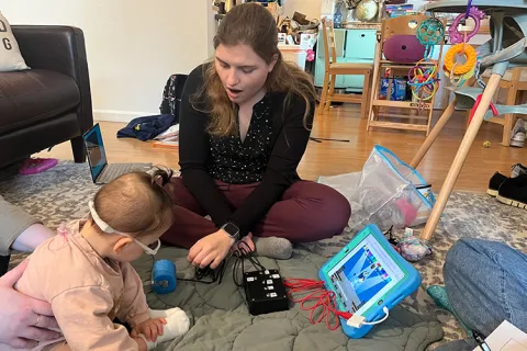Adult person and a child playing with a switch kit