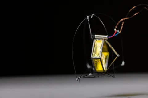 A robot is shown in mid-air.