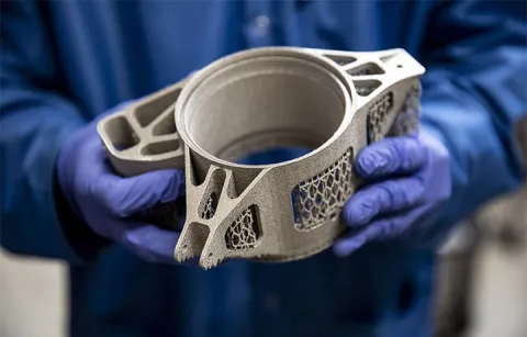 A pair of hands holding a 3D printed wheel hub mount