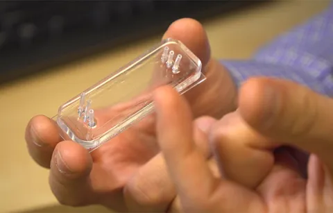 A hand holding the new device