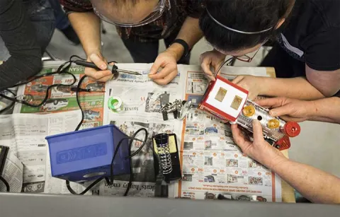 students in workshop adapting a toy