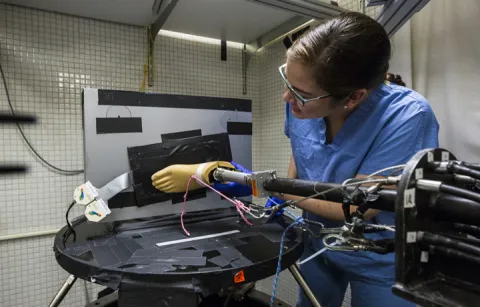 Researcher working with prosthetic
