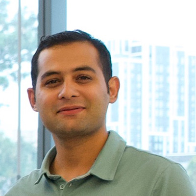 Ehsan Aalaei is smiling in front of a window