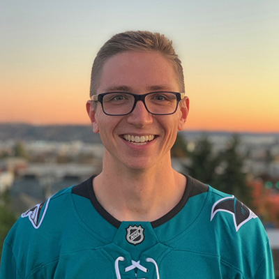 Elijah Kuska smiling with a sunset in the background