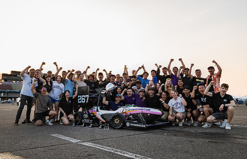 The UW Formula Motorsports team surrounds their race car after the competition.