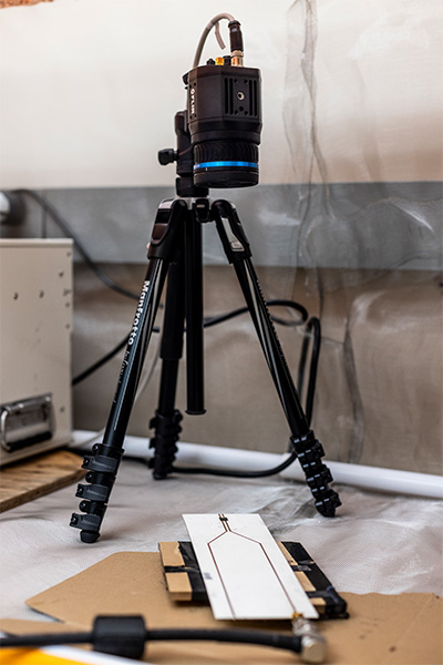 A thermal camera is set up on a table and points down at the radio frequency applicator