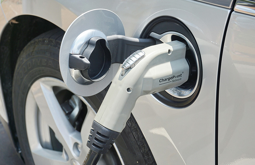 A charger is plugged into an electric vehicle