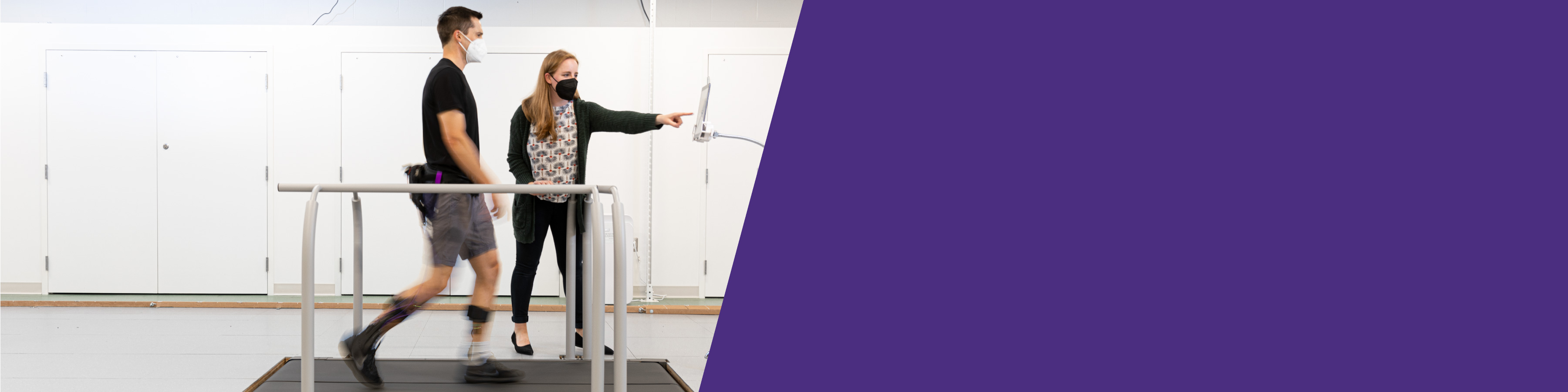 Man walking on a treadmill wearing an exoskeleton device
