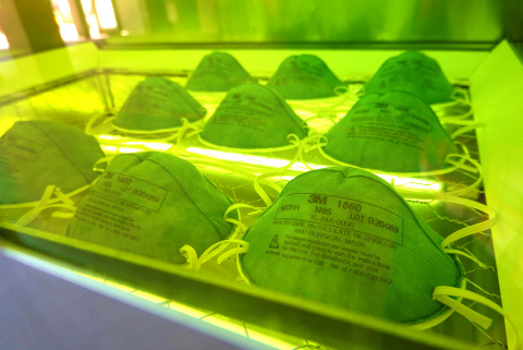 15 N95 masks inside a glowing green chamber