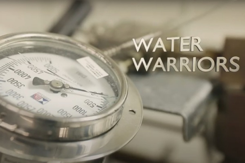 Image of a pressure guage and the title text "water warriors"