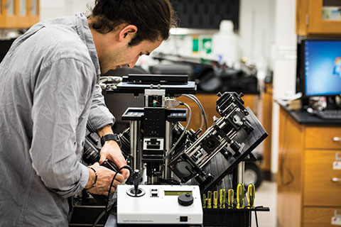 Researcher working on an electronic equipment