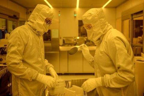 Two scientists in a lab wearing PPE