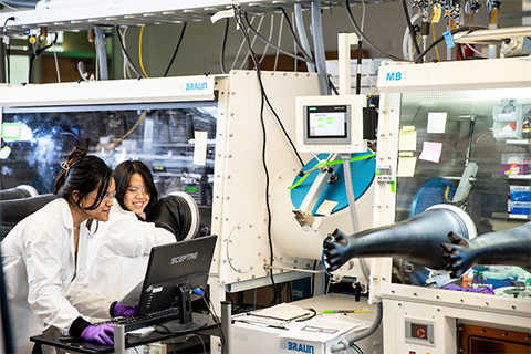 Two women looking at a computer in a lab