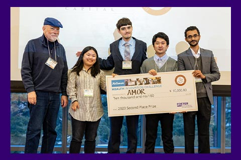 Group photo of winning team holding prize large check