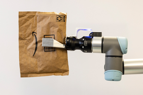Robotic grasper holding an Amazon mailer