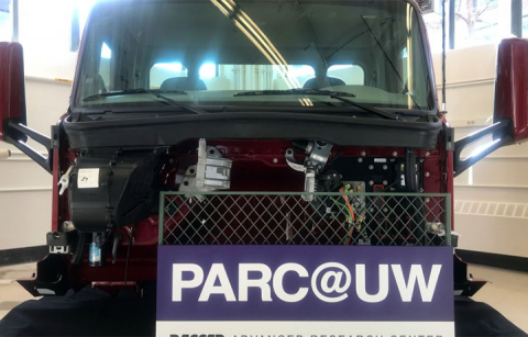 A truck with a sign that says "PARC@UW" in front of it