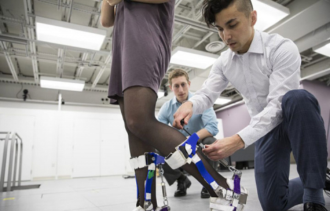 Researcher adjusting device on a user's leg